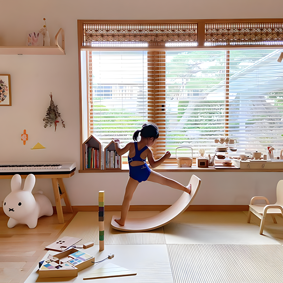 A girl joyfully balances in her room with the Wooden Board for Balance Montessori Toy and Decor, enhancing playtime and decor.