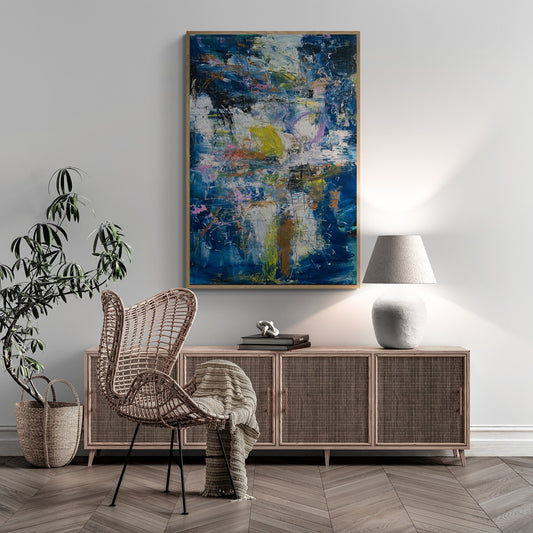 Boho room with rattan cabinet and chair featuring hand-painted abstract wall art.