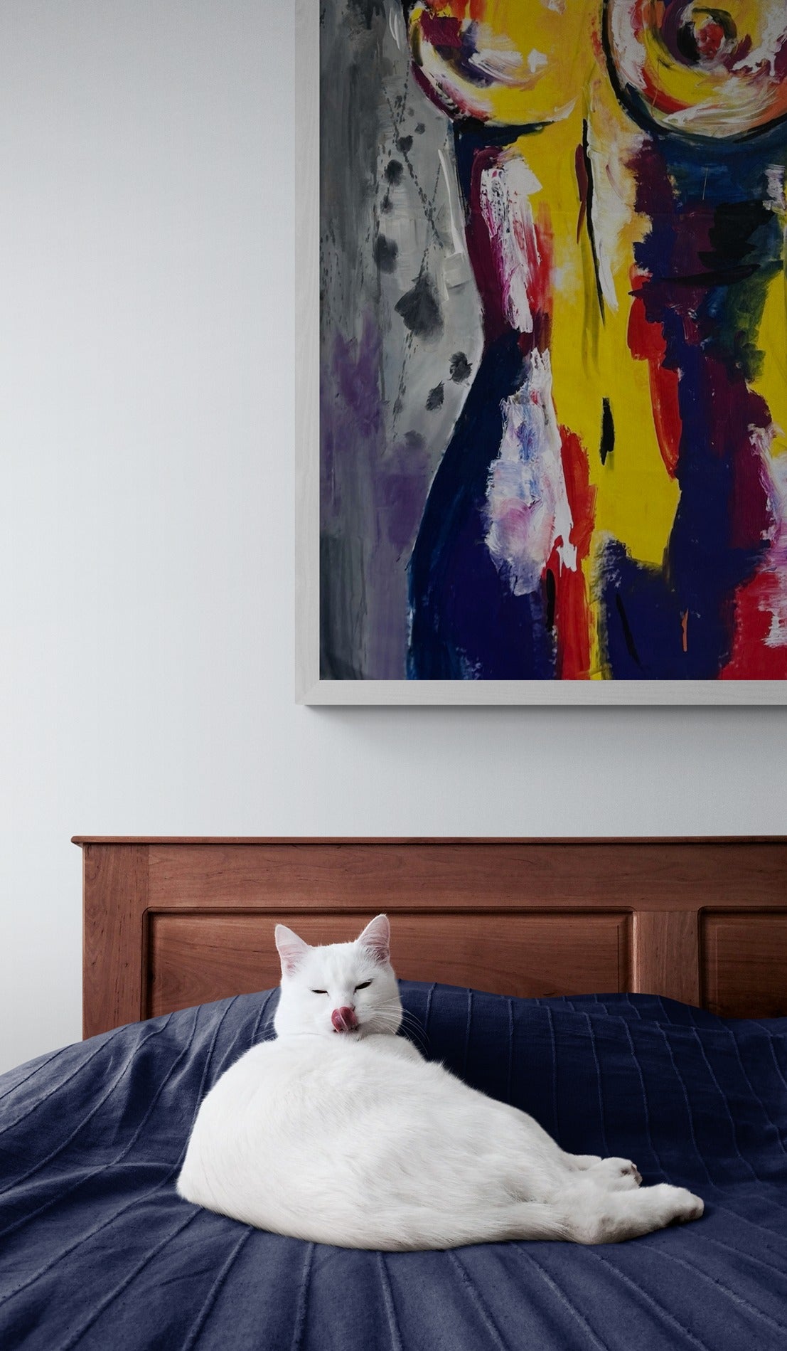 A large original hand-painted abstract canvas wall art piece featuring a cute white cat lying on a bed, adding charm and character to the room's decor.