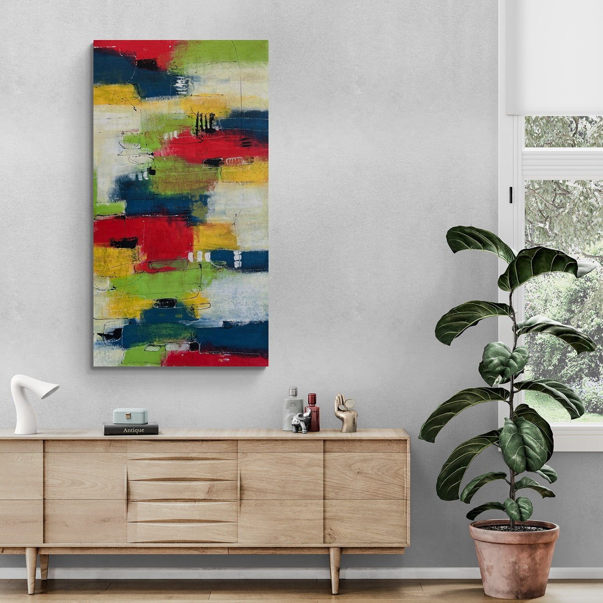 Abstract Wall art in living room with a long cabinet and a plant.