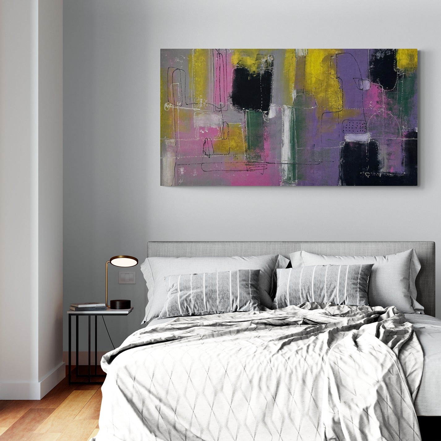 Large original hand painted wall art inside a modern bedroom with a side table