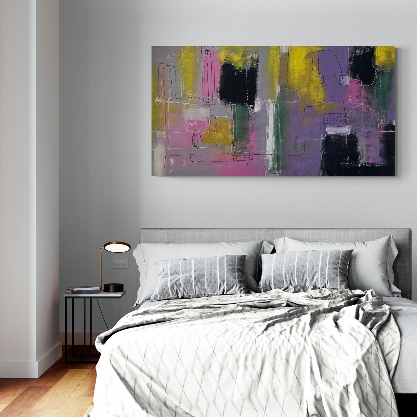 Large original hand painted wall art inside a modern bedroom  with a side table