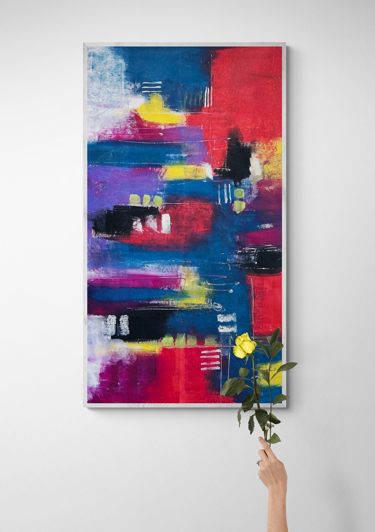a woman holding a yellow flower in front of a large hand painted abstract wall art