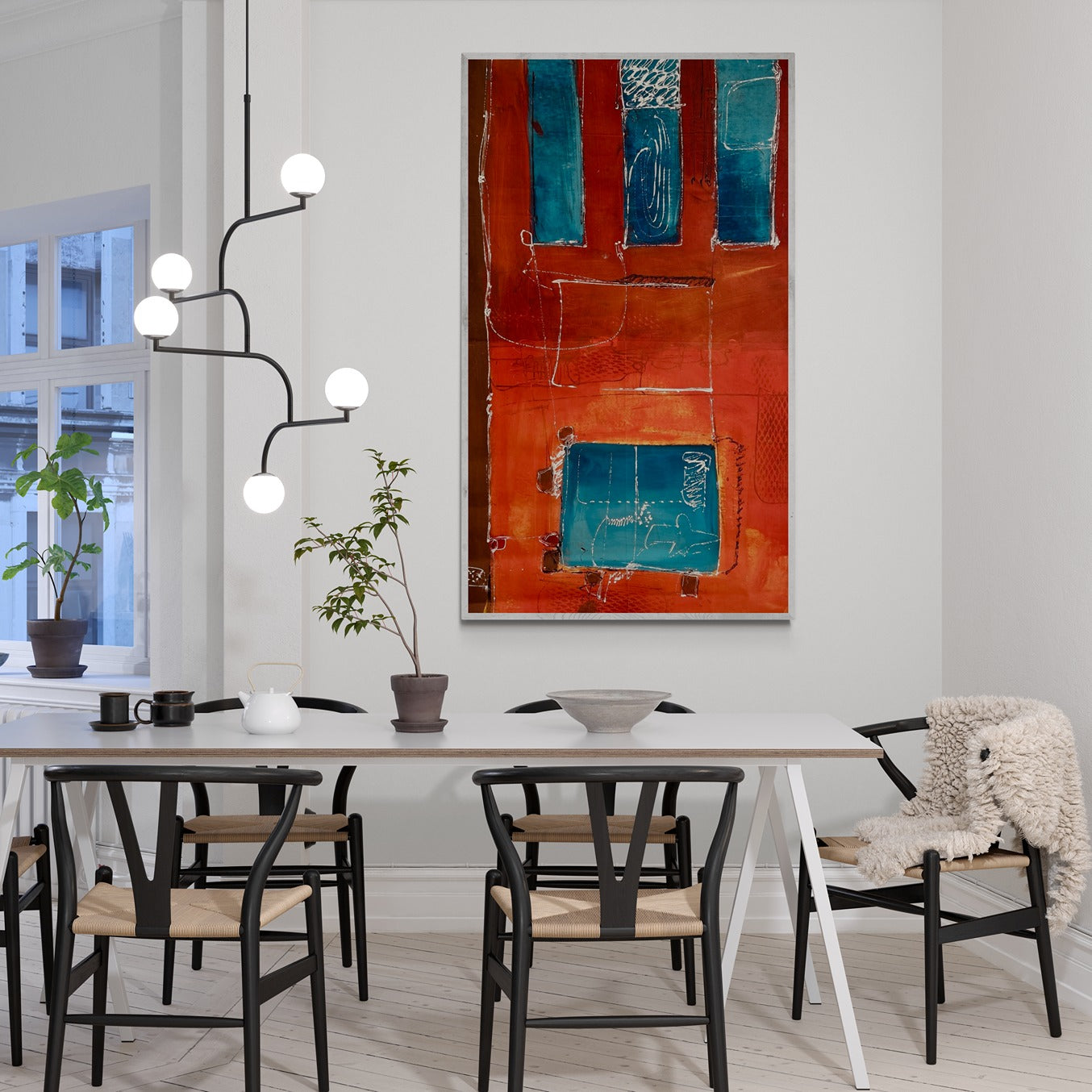 Large original wall art in a dining room with hanging lights.