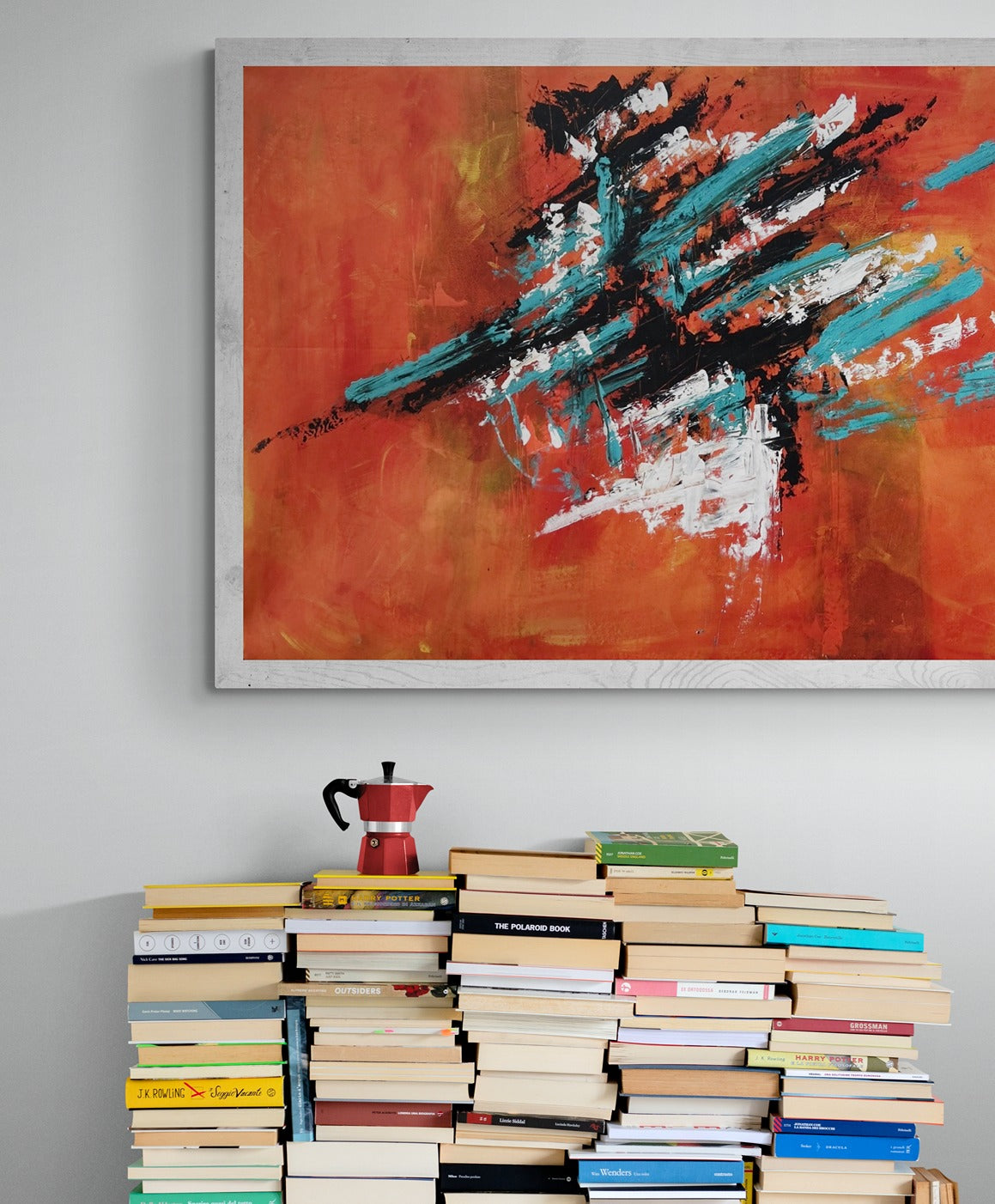 Original hand-painted abstract canvas wall art displayed alongside a coffee pot resting on a stack of books, adding artistic flair to a cozy reading nook or coffee corner.