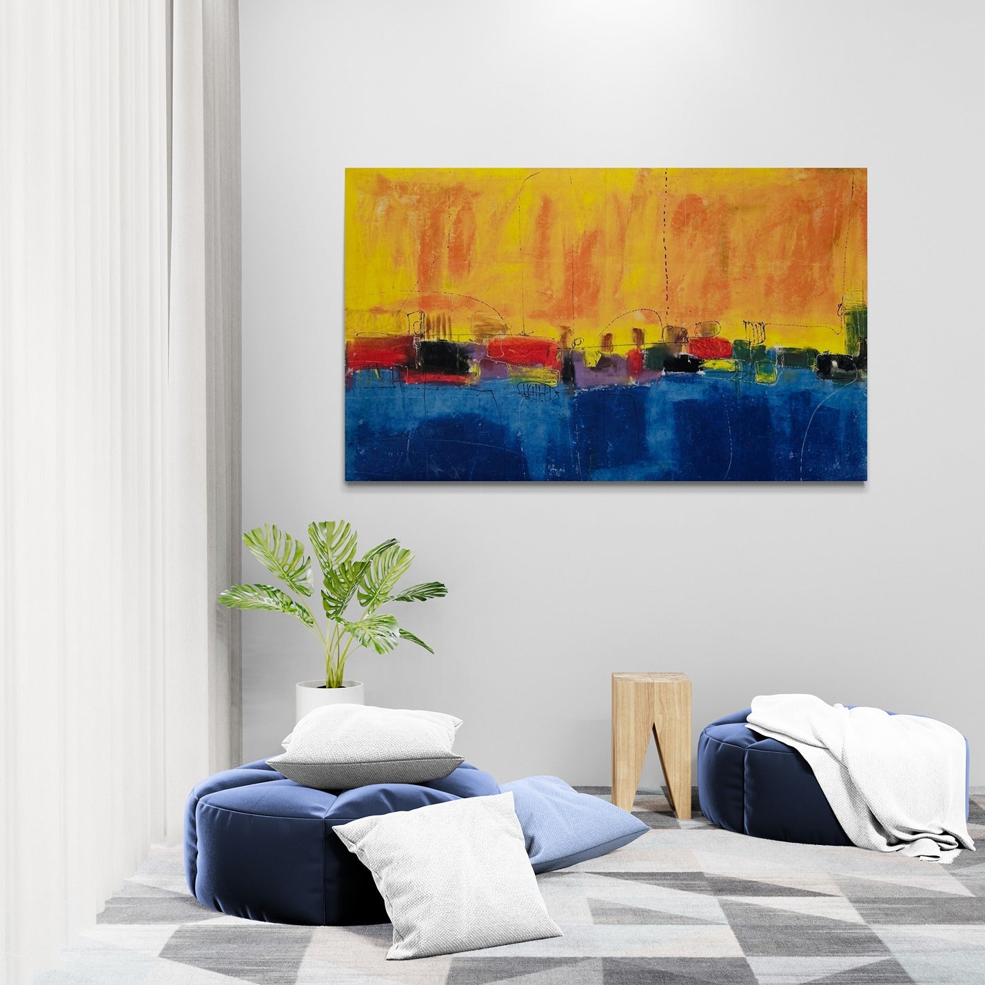 Abstract wall art in a relaxing room featuring large poufs.