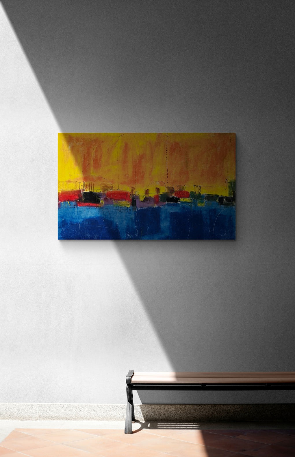 A big abstract original wall art piece mounted on a shaded exterior wall with a bench seat below.