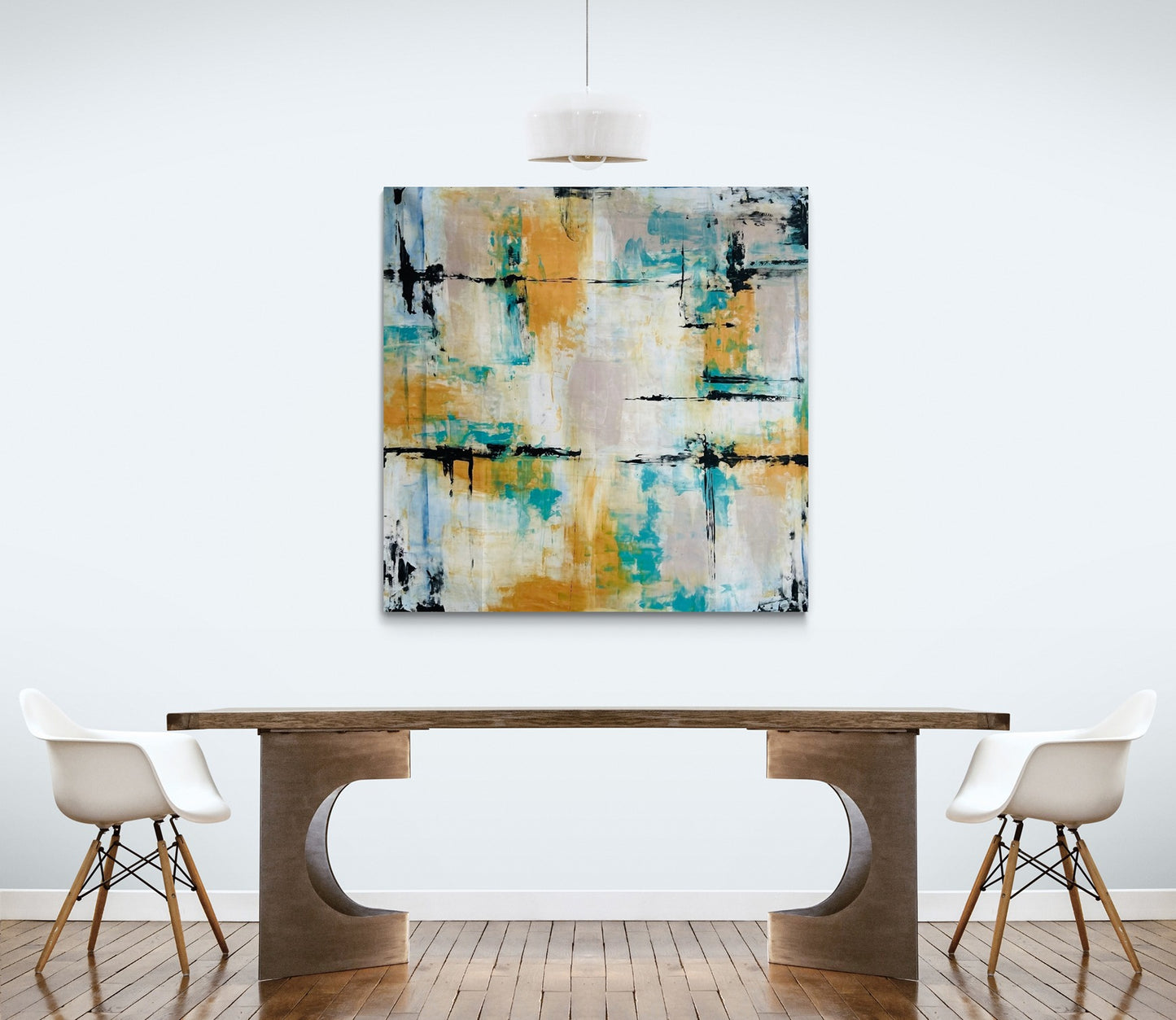 Big abstract painting in a dining room with a stylish solid wood table