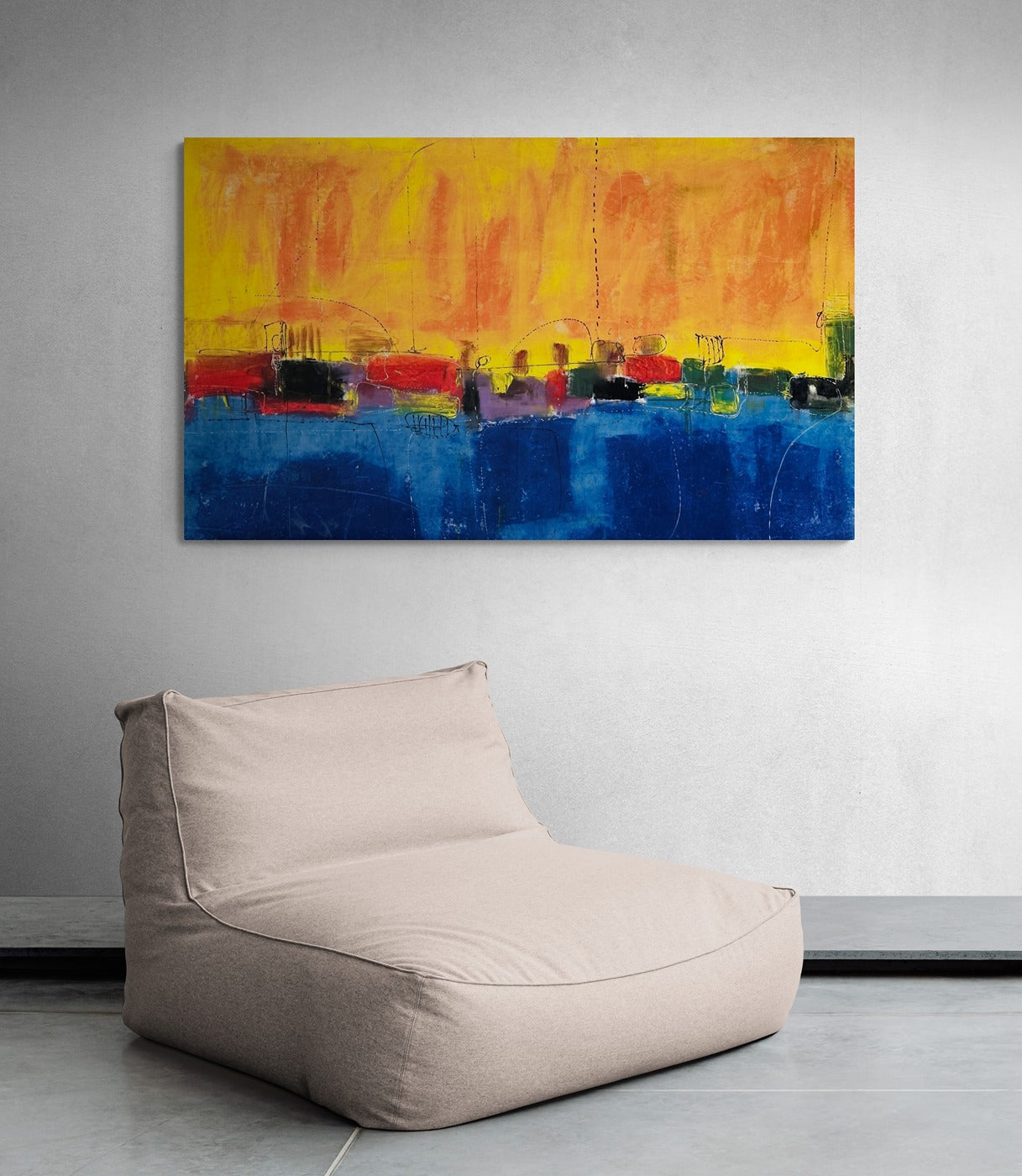 A colorful wall art piece hanging above a large, relaxing bean bag chair.