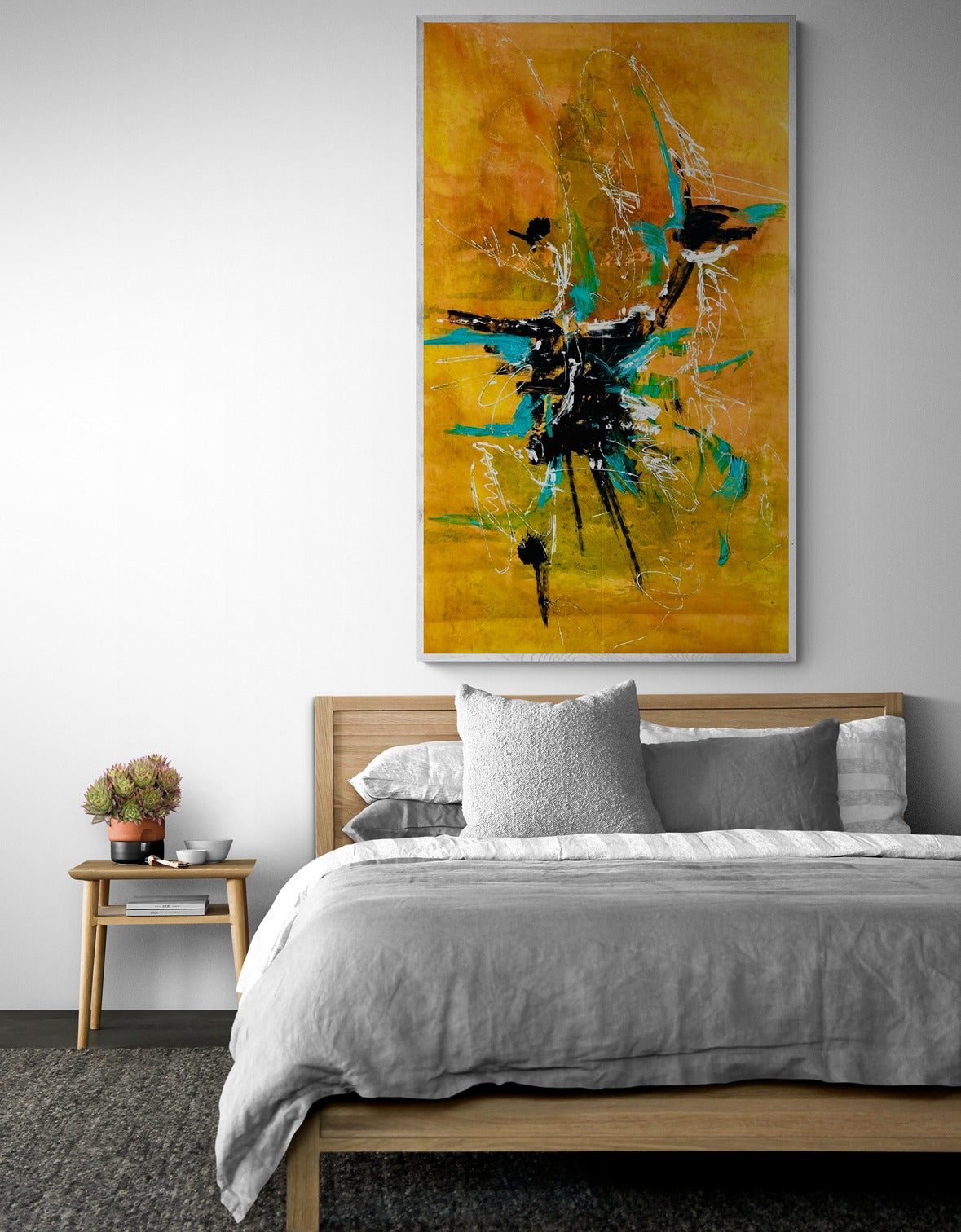 Comfy bedroom with wooden bed and side table featuring orange abstract large wall art.