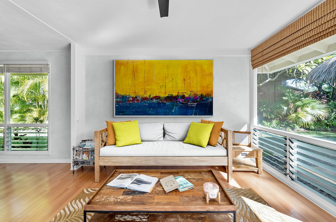 Huge wall art adorns the living room, offering a captivating backdrop against the tropical garden views, creating a serene and picturesque ambiance.