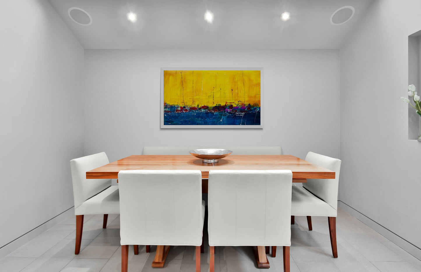 A large painting graces the dining room, complementing the luxurious leather chairs and adding sophistication to the space.