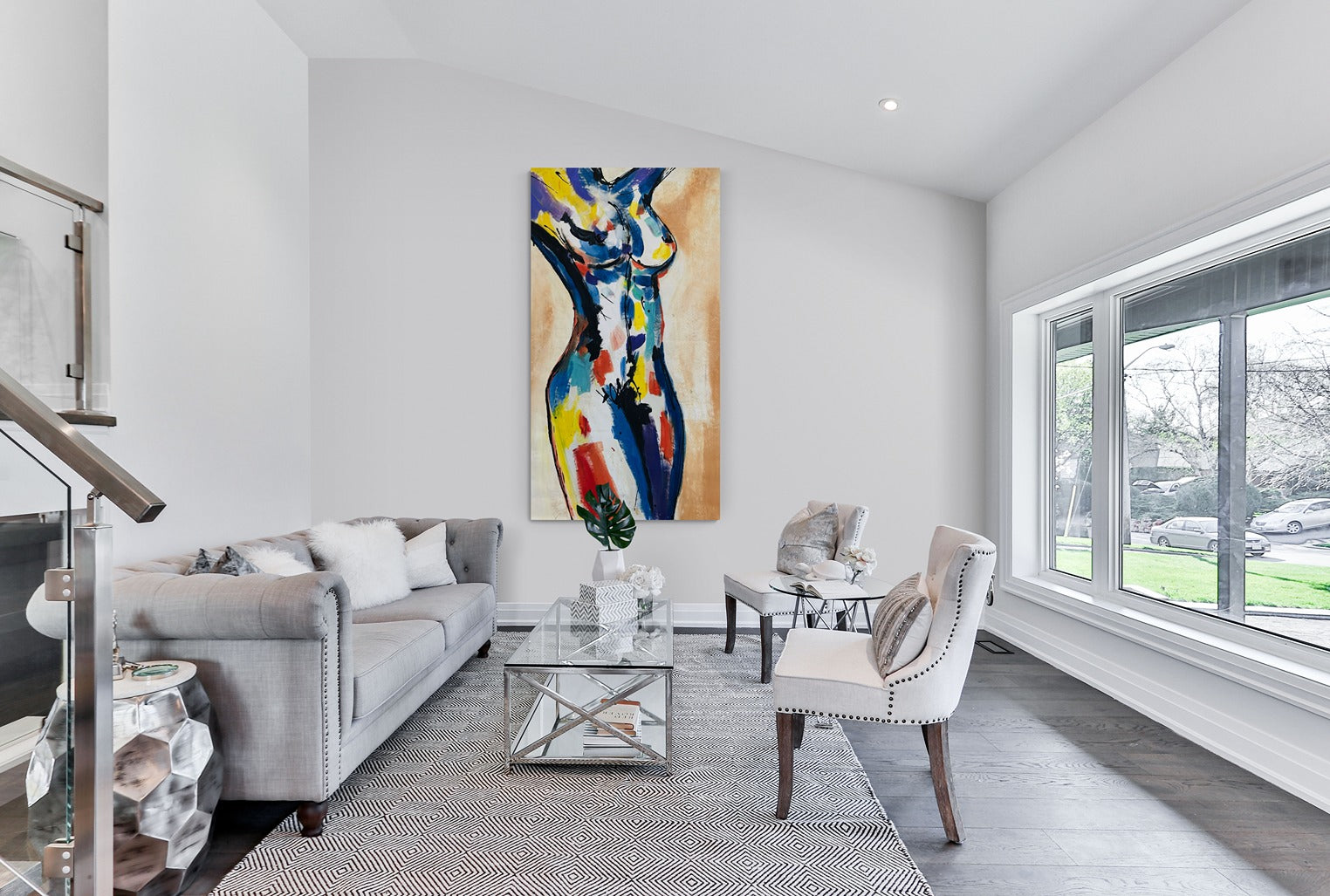 Original hand-painted abstract canvas wall art graces the walls of a large, bright, and comfortable family room, infusing the space with artistic vibrancy and warmth.