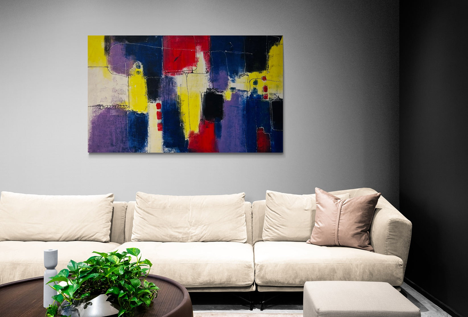 Original hand-painted abstract canvas wall art adorns the space above a long and comfortable sofa in a cozy living room, adding artistic flair and warmth to the ambiance.