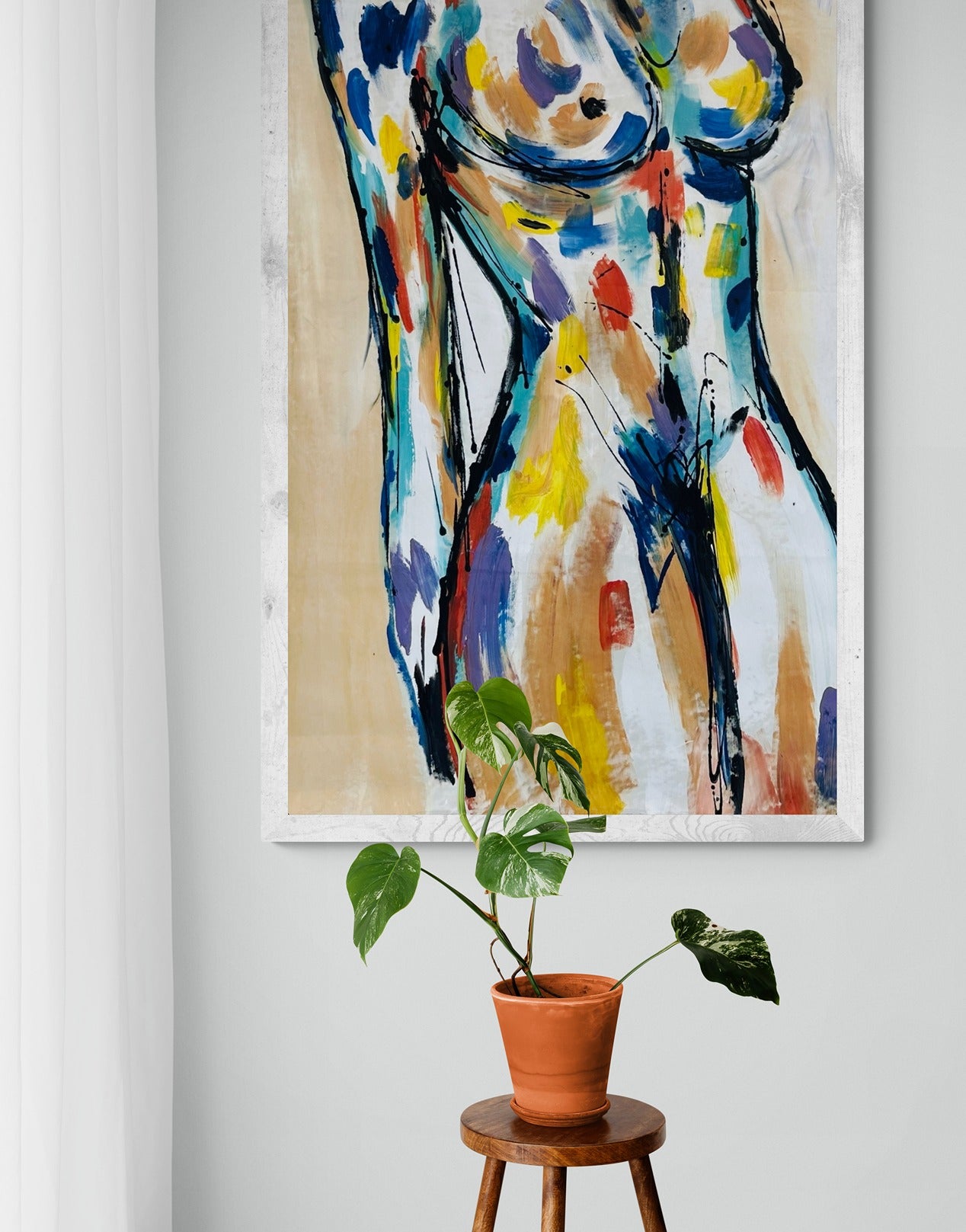 Original hand-painted abstract canvas wall art displayed with a potted plant on a wooden stool, adding natural and artistic elements to the decor.