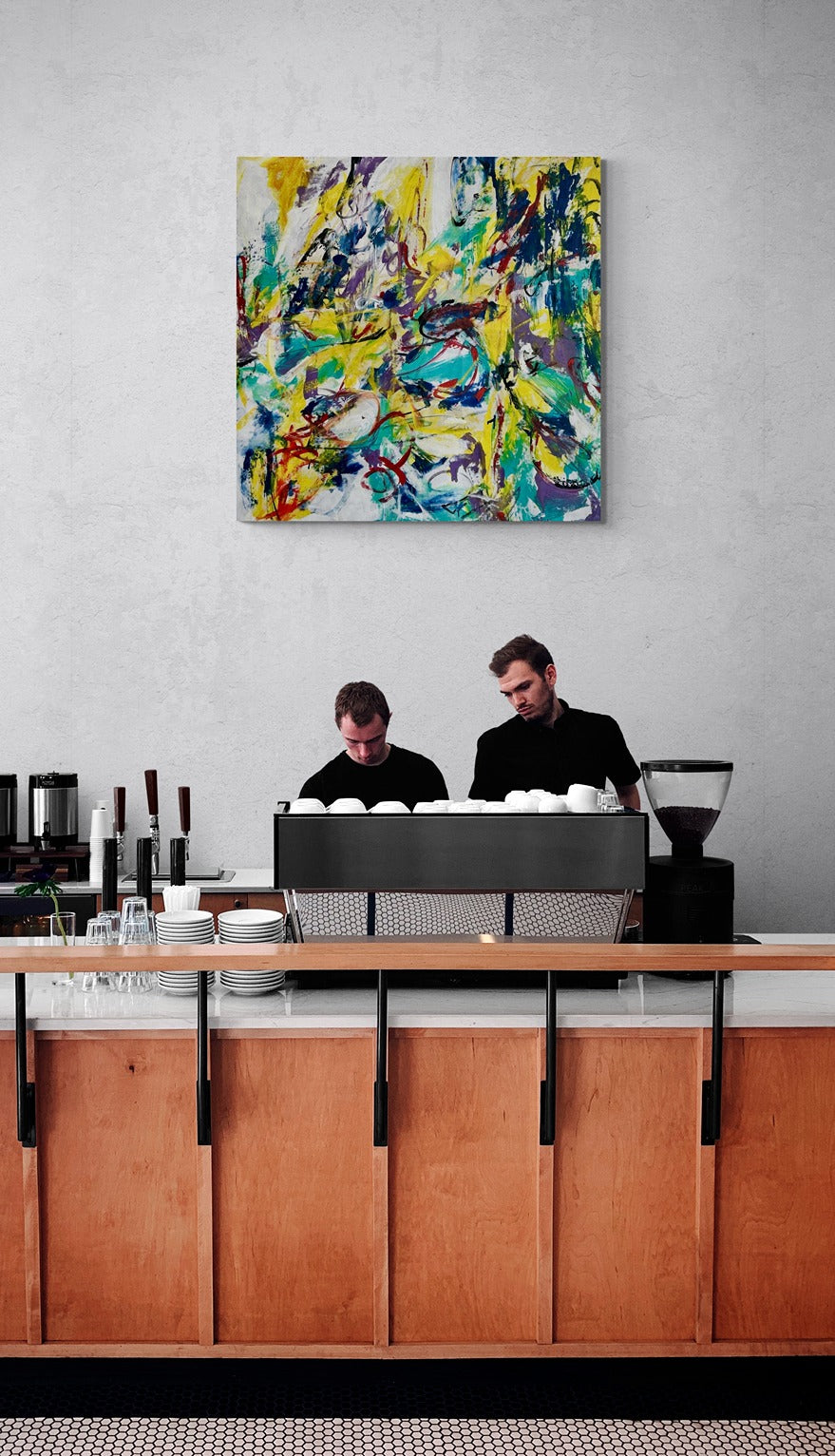 Wall art depicting busy baristas in a coffee shop